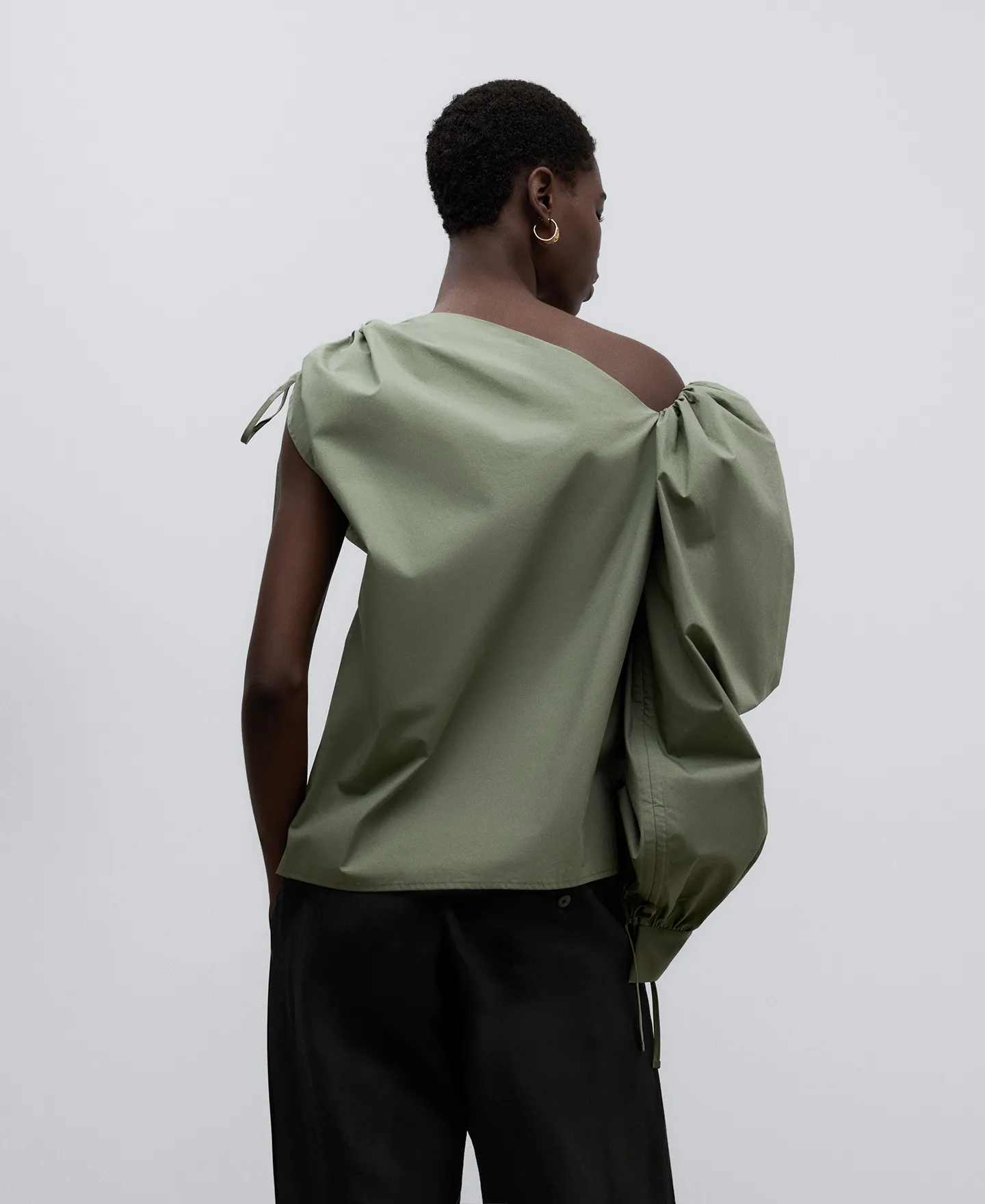 Green asymmetric top woman